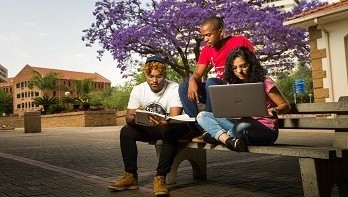 Students on Hatfield campus with laptop and books